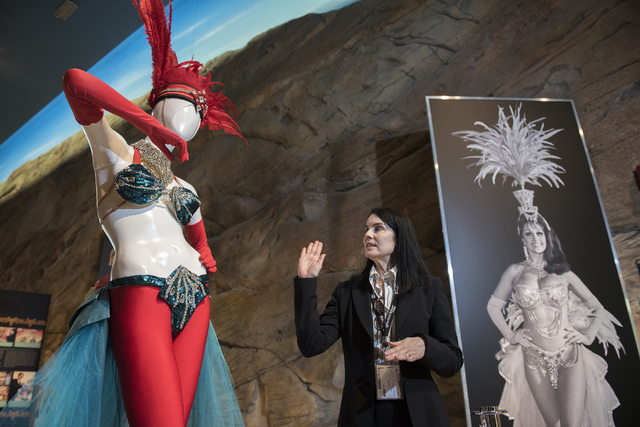 Summerlin-area resident Karan Feder, guest curator of costumes and textiles at the Nevada State Museum, explains the history of stage costumes from "The Les Folies Bergere" exhibit at the museum i ...