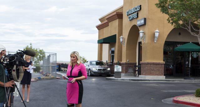 A television news reporter stands outside of Starbucks at 7260 S. Rainbow Blvd. in Las Vegas on Tuesday, Sept. 27, 2016. A fatal shooting broke out inside the coffee shop on Sunday, Sept. 25, 2016 ...