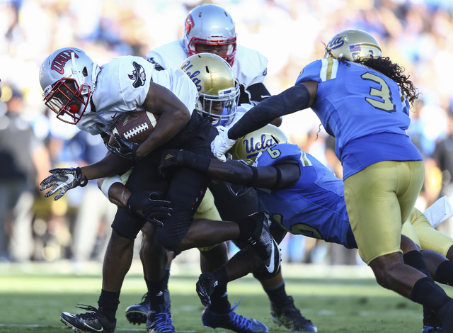 UNLV Rebels running back Lexington Thomas (3) pushes past UCLA defense to score a touchdown during a football game at the Rose Bowl in Pasadena, Calif. on Saturday, Sept. 10, 2016. Chase Stevens/L ...