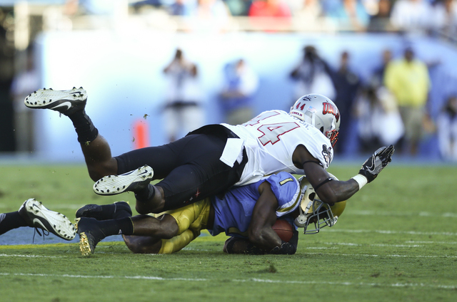 UNLV Rebels defensive back Kenny Keys (44) takes down UCLA Bruins wide receiver Ishmael Adams (1) during a football game at the Rose Bowl in Pasadena, Calif. on Saturday, Sept. 10, 2016. Chase Ste ...