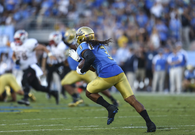 UCLA Bruins defensive back Randall Goforth (3) drives the ball after intercepting a throw from UNLV during a football game at the Rose Bowl in Pasadena, Calif. on Saturday, Sept. 10, 2016. Chase S ...