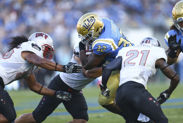 UNLV players swarm UCLA Bruins running back Jalen Starks (32) during a football game at the Rose Bowl in Pasadena, Calif. on Saturday, Sept. 10, 2016. Chase Stevens/Las Vegas Review-Journal Follow ...