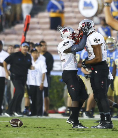 UNLV Rebels running back David Greene (22), left, and UNLV Rebels tight end Andrew Price (88) celebrate a catch from Price during a football game against UCLA at the Rose Bowl in Pasadena, Calif.  ...