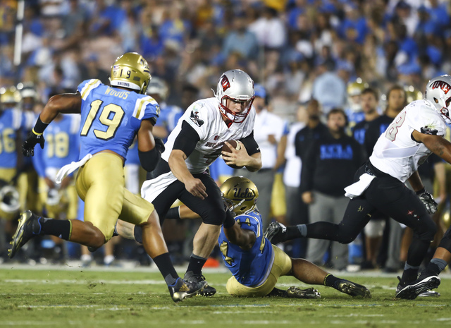 UNLV Rebels quarterback Johnny Stanton (4) gets past UCLA defense, including linebacker Josh Woods (19), during a football game at the Rose Bowl in Pasadena, Calif. on Saturday, Sept. 10, 2016. UC ...