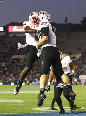 UNLV Rebels wide receiver Darren Woods Jr. (10), left, celebrates a touchdown by UNLV Rebels quarterback Johnny Stanton (4), right, while playing UCLA during a football game at the Rose Bowl in Pa ...