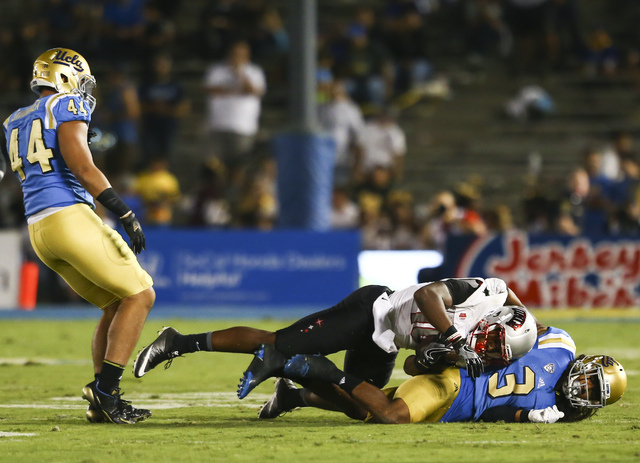 UCLA Bruins defensive back Randall Goforth (3) takes down UNLV Rebels wide receiver Darren Woods Jr. (10) during a football game at the Rose Bowl in Pasadena, Calif. on Saturday, Sept. 10, 2016. U ...