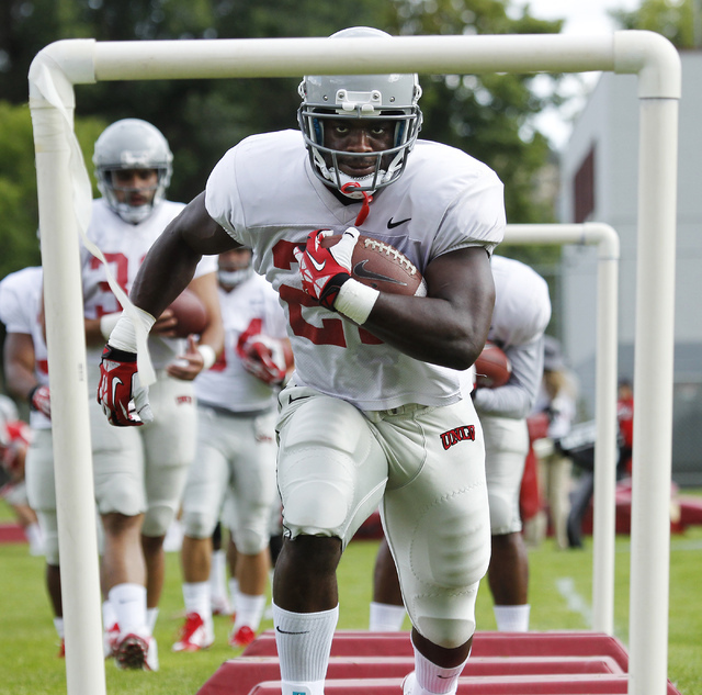 Running back David Greene (22) runs a drill during the opening day of UNLV's training camp up in Ely on Aug. 10, 2014. (Jason Bean/Las Vegas Review-Journal)