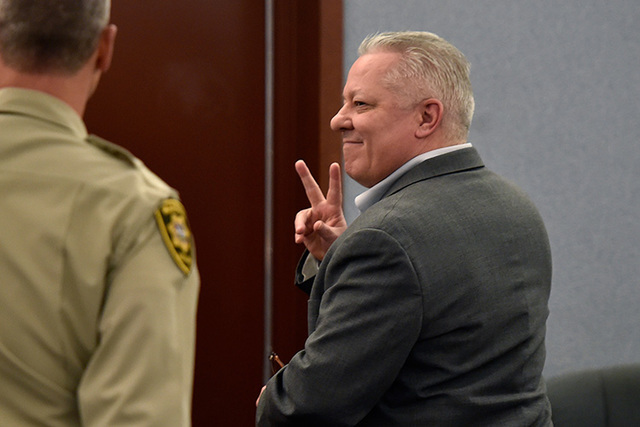David Frostick signals to his family as he exits court at the Regional Justice Center Friday, Sept. 16, 2016, in Las Vegas. Frostick was sentence to life in prison for the murder of his fiancee in ...