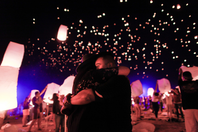 John Aboyo, right, and Denise Serrano embrace one another as lanterns are released into the sky at Rise Lantern Festival at the Moapa River Indian Reservation on Saturday, Oct. 10, 2015. Chase Ste ...
