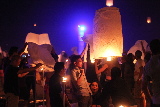 Attendees dodge a lantern flying through the crowd at Rise Lantern Festival at the Moapa River Indian Reservation on Saturday, Oct. 10, 2015. Chase Stevens/Las Vegas Review-Journal Follow @cssteve ...