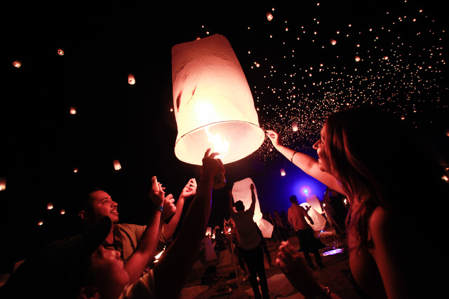 Heather Jamal, right, and Josh Beattie, second from left, prepare to release a lantern into the sky at Rise Lantern Festival at the Moapa River Indian Reservation on Saturday, Oct. 10, 2015. Chase ...