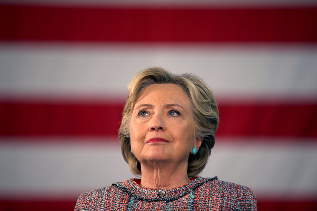 U.S. Democratic presidential nominee Hillary Clinton listens to former Vice President Al Gore talk about climate change at a rally at Miami Dade College in Miami, Florida, U.S. October 11, 2016. ( ...