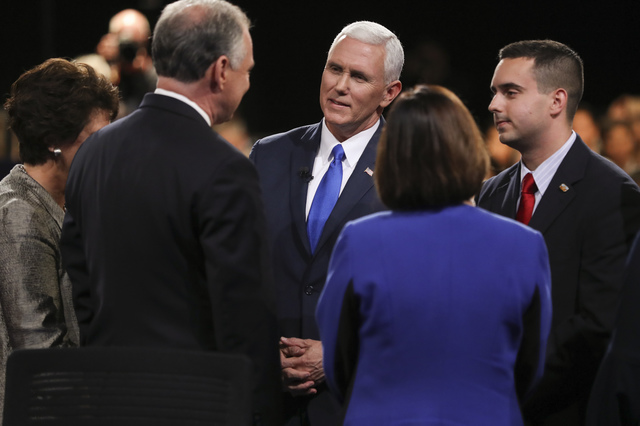 Republican vice-presidential nominee Gov. Mike Pence and Democratic vice-presidential nominee Sen. Tim Kaine, left, talk after the vice-presidential debate at Longwood University in Farmville, Va. ...
