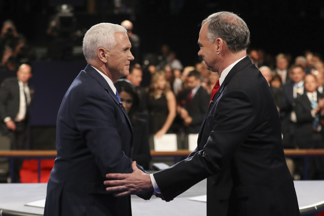 Republican vice-presidential nominee Gov. Mike Pence and Democratic vice-presidential nominee Sen. Tim Kaine shake hands after the vice-presidential debate at Longwood University in Farmville, Va. ...