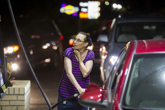 Beth Johnson fills up her car after waiting in line at a Sunoco gas station in advance of Hurricane Matthew in Mt. Pleasant, South Carolina on Tuesday, Oct. 4, 2016. The state will issue an evacu ...