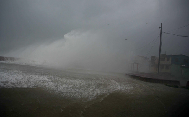 Surf and wind from Hurricane Matthew crash on the waterfront in Baracoa, Cuba, Tuesday, Oct. 4, 2016. The dangerous Category 4 storm blew ashore around dawn in Haiti. It unloaded heavy rain as it  ...