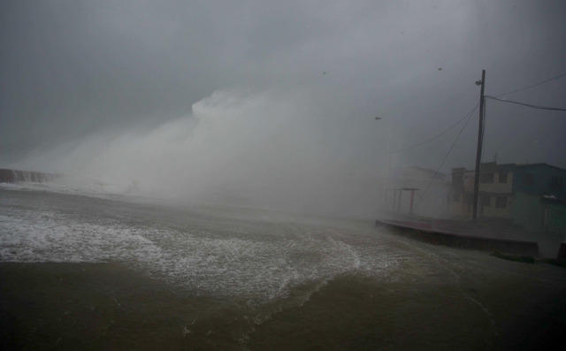 Surf and wind from Hurricane Matthew crash on the waterfront in Baracoa, Cuba, Tuesday, Oct. 4, 2016. The dangerous Category 4 storm blew ashore around dawn in Haiti. It unloaded heavy rain as it ...
