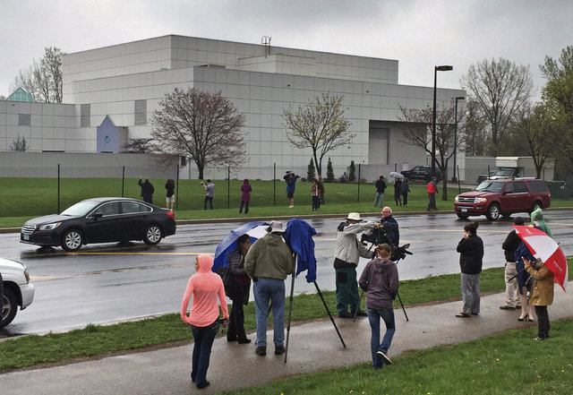 People stand outside the entertainer Prince's Paisley Park compound in Chanhassen, Minn., April 21, 2016. A few Paisley Park tours begin Thursday, Oct. 6. (Jim Gehrz/Star Tribune via AP)