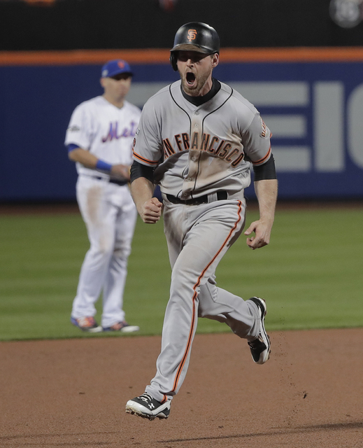 San Francisco Giants'  Conor Gillaspie reacts as he rounds the bases after hitting a three-run home run against the New York Mets during the ninth inning of the National League wild-card baseball  ...