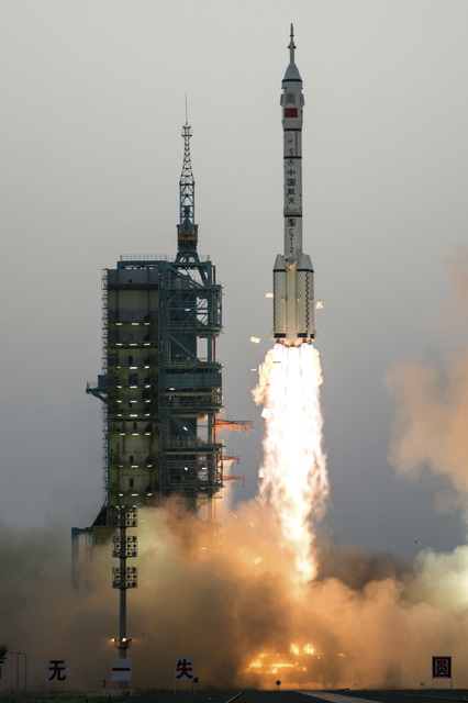 China's Shenzhou 11 spaceship onboard a Long March-2F carrier rocket takes off from the Jiuquan Satellite Launch Center in northwest China's Gansu province on Monday Oct. 17, 2016.  (Chinatopix vi ...