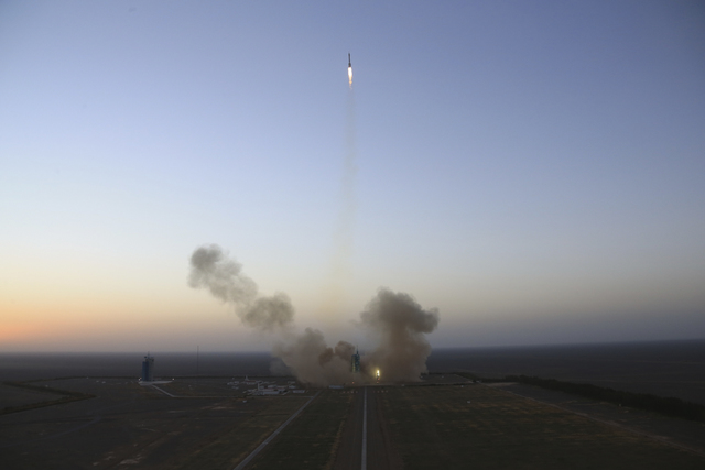 In this photo released by Xinhua News Agency, the Long March-2F carrier rocket carrying China's Shenzhou 11 manned spacecraft blasts off from the launch pad at the Jiuquan Satellite Launch Center  ...