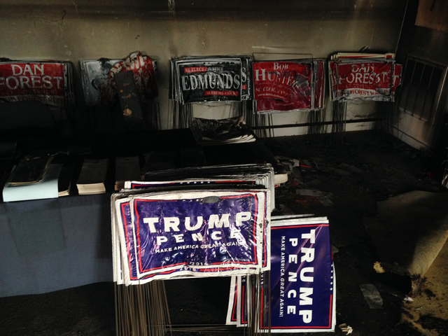 Melted campaign signs are seen at the Orange County Republican Headquarters in Hillsborough, NC on Sunday, Oct. 16, 2016. (AP Photo/Jonathan Drew)
