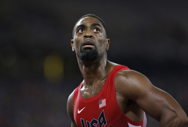 In this Aug. 23, 2015, file photo, Tyson Gay looks at his time from a men's 100-meter semifinal at the World Athletics Championships at the Bird's Nest stadium in Beijing. (David J. Phillip,/AP)