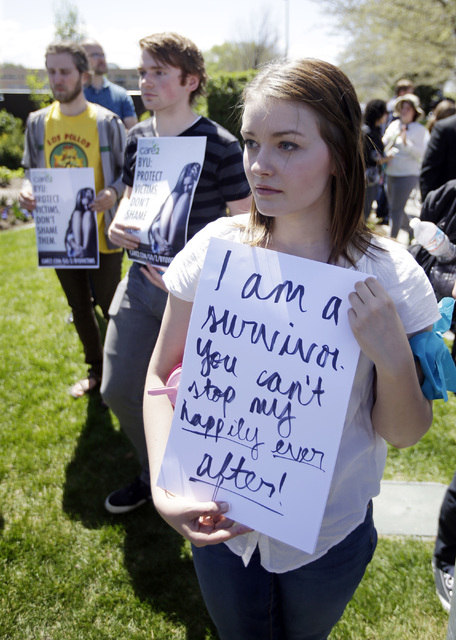 Katie Townsley stands in solidarity with rape victims on the campus of Brigham Young University during a sexual assault awareness demonstration in Provo, Utah. (Rick Bowmer/AP)