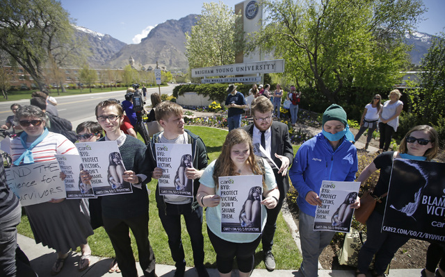 Protesters stand in solidarity with rape victims on the campus of Brigham Young University during a sexual assault awareness demonstration, in Provo, Utah. (Rick Bowmer/AP)