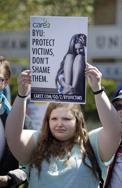 A protester stands in solidarity with rape victims on the campus of Brigham Young University during a sexual assault awareness demonstration in Provo, Utah. (Rick Bowmer/AP)