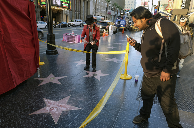 A man takes a photo of the vandalized star for Republican presidential candidate Donald Trump on the Hollywood Walk of Fame, Wednesday, Oct. 26, 2016, in Los Angeles. (Richard Vogel/AP)