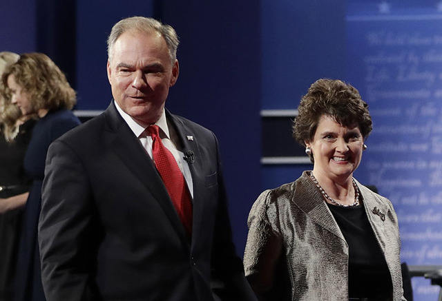Sen. Tim Kaine walks off the stage with his wife Anne Holton following the vice-presidential debate at Longwood University in Farmville, Va., Tuesday, Oct. 4, 2016. (Julio Cortez/The Associated Press)