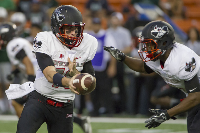 UNLV quarterback Dalton Sneed, left, hands off the football to running back Lexington Thomas, right, during the first quarter of an NCAA college football game against Hawaii, Saturday, Oct. 15, 20 ...
