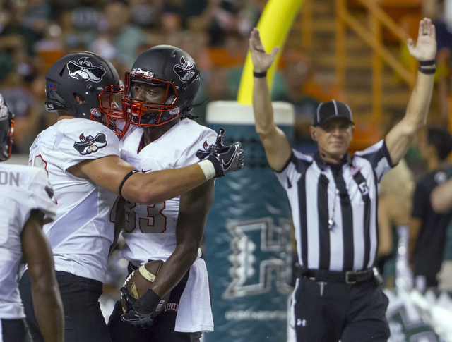 UNLV tight end Tim Holt, left, congratulates wide receiver Devonte Boyd, right, after Boyd caught a pass for a touchdown in the first quarter of an NCAA college football game against Hawaii, Satur ...