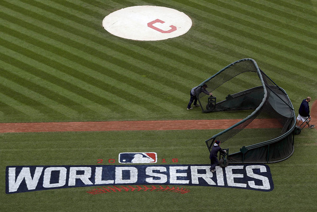 Members of the grounds crew prepare the field for batting practice for baseball's upcoming World Series between the Cleveland Indians and the Chicago Cubs, Monday, Oct. 24, 2016 in Cleveland. (Dav ...