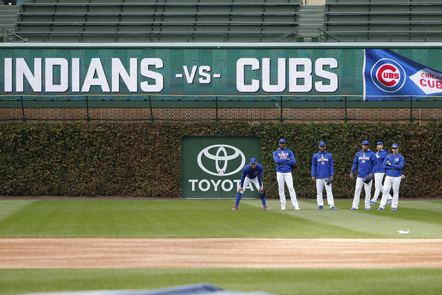 Chicago Cubs players work out in the outfield during batting practice for Friday's Game 3 of the Major League Baseball World Series against the Cleveland Indians, Thursday, Oct. 27, 2016, in Chica ...
