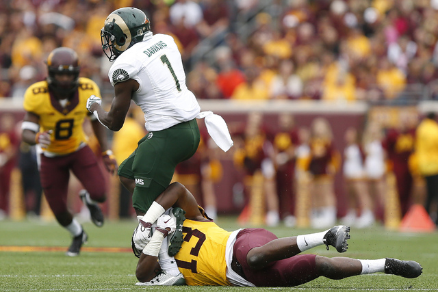 Colorado State running back Dalyn Dawkins (1) is tackled by Minnesota linebacker Jonathan Celestin during an NCAA college football game Saturday, Sept. 24, 2016, in Minneapolis. (Stacy Bengs/AP)