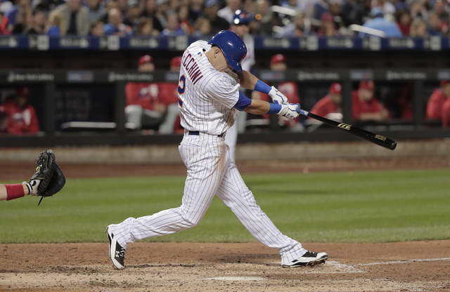 New York Mets' Gavin Cecchini swings for his first hit in the majors, driving in a run during the sixth inning of a baseball game against the Philadelphia Phillies, Saturday, Sept. 24, 2016, in Ne ...