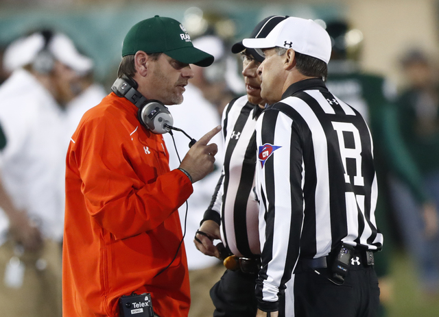 Colorado State Rams head coach Mike Bobo, left, talks to referee Brad Van Vark while facing Utah State in the first half of an NCAA college football game Saturday, Oct. 8, 2016, in Fort Collins, C ...