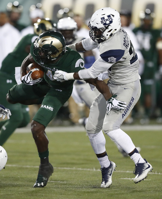 Colorado State wide receiver Michael Gallup, left, is stopped after a short win by Utah State safety Jontrell Rocquemore in the first half of an NCAA college football game Saturday, Oct. 8, 2016, ...