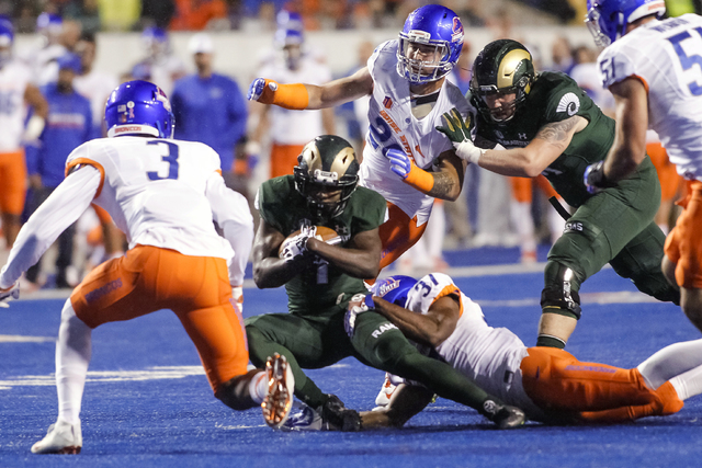 Colorado State running back Dalyn Dawkins (1) is brought down by Boise State safety Cameron Hartsfield (37) during the first half of an NCAA college football game in Boise, Idaho, Saturday, Oct. 1 ...