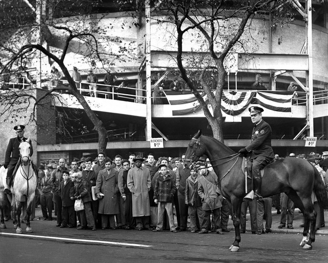 In this Oct. 10, 1945, photo, fans wait to buy bleacher tickets to the seventh game of the World Series between the Chicago Cubs and Detroit Tigers at Wrigley Field in Chicago. (Mel Larson/Chica ...