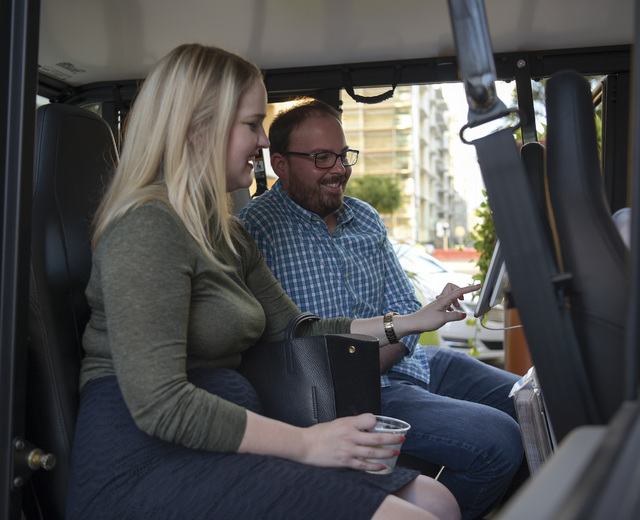 Ashly Anderson, left, of the Tampa Downtown Partnership, and Jeremy Rex, of the City of Tampa, use with a tablet that provides information about restaurants, during the first day of operation of D ...
