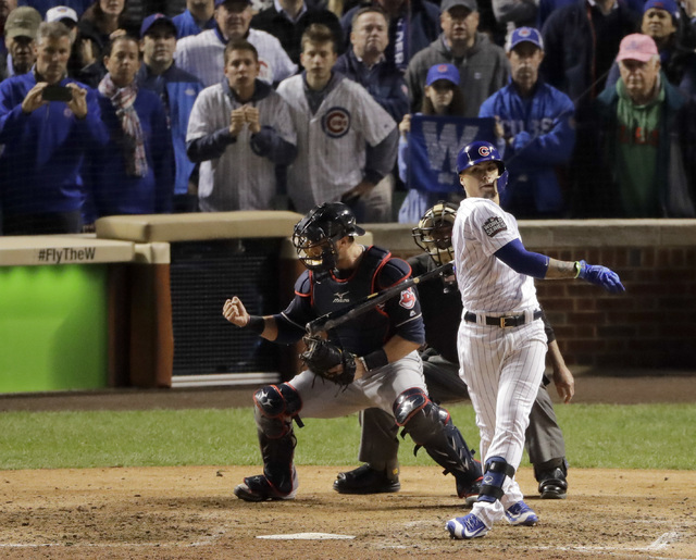 Cleveland Indians catcher Yan Gomes, left, celebrates after Chicago Cubs' Javier Baez makes the final out in Game 3 of the World Series Friday, Oct. 28, 2016, in Chicago. (Charlie Riedel/The Assoc ...