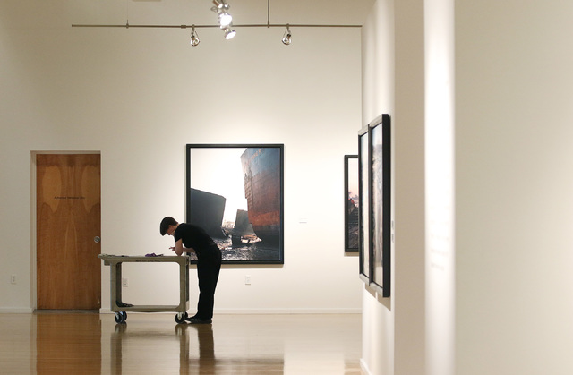 Gallery worker Deanne Sole prepares for the opening of Edward Burtynsky’s photography exhibit “Oil” at UNLV's Marjorie Barrick Museum. Ronda Churchill/Las Vegas Review-Journal