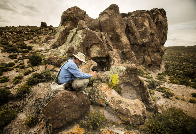 Ecologist and outdoorsman Jim Boone photographs a rock formation in Garden Valley during a May 2015 tour of what is now part of Basin and Range National Monument. Boone was recognized Saturday for ...