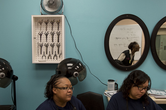 Cosmetology instructor Dorothy Muhammad, reflected in mirror, leads an afternoon class while inmates Kimala Kimblr and Candice Austin take notes on Thursday, June 30, 2016, at Florence McClure Wom ...
