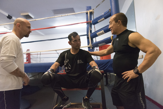 Nonito Donaire, center, speaks with Ismael Salas, right, and Clarence "Bones" Adams during a training session at Bones Adams Boxing Gym in Las Vegas on Monday, Oct. 17, 2016, to defend Donaire's S ...