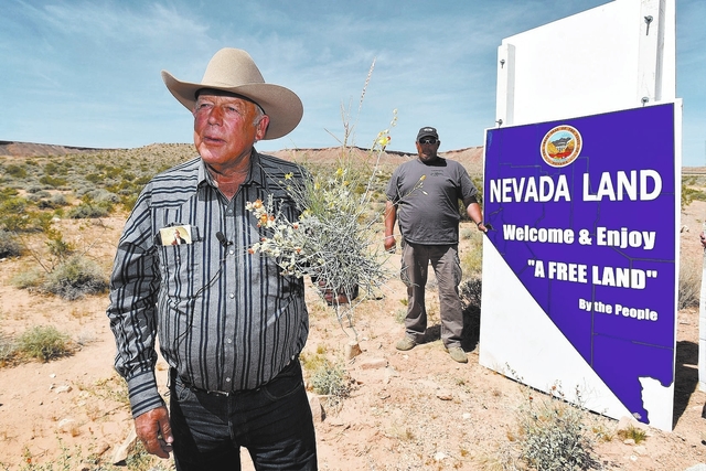 Rancher Cliven Bundy displays a bouquet of desert foliage, which his cattle grazes on, during a news conference at an event near his ranch in Bunkerville on Saturday, April 11, 2015. (David Becker ...