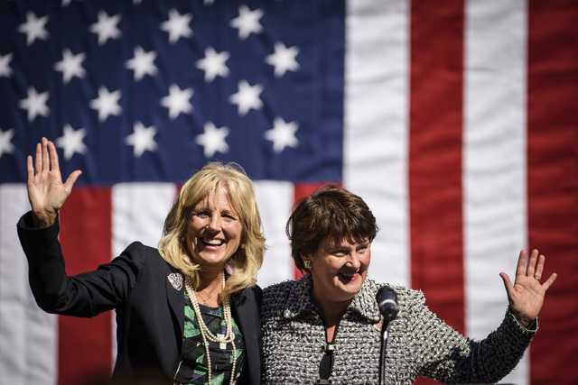 Jill Biden, wife of Vice President Joe Biden, and Anne Holton, wife of Democratic vice presidential candidate Tim Kaine, wave after speaking on Saturday, Oct. 22, 2016, at Fayetteville Technical C ...